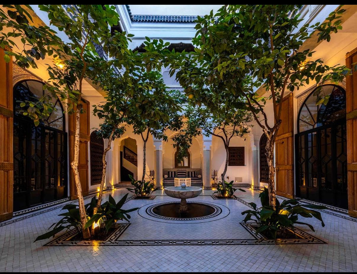 Riad Sa'eed inner courtyard at night with warm lighting and fountain