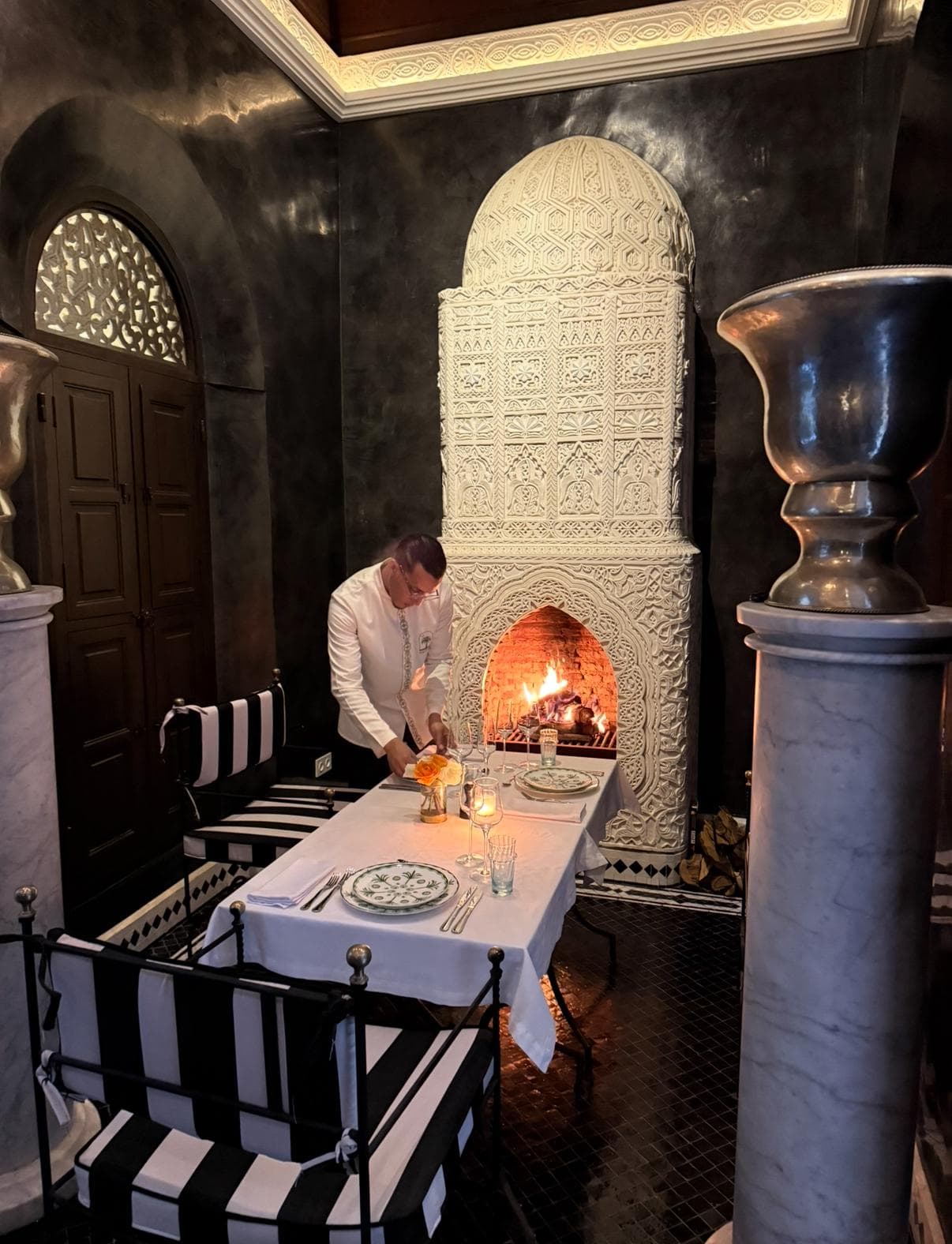 Private dinner setup by ornate Moroccan fireplace